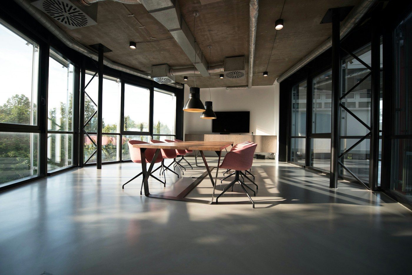 Illustration: modern meeting room with a long wooden table and glass walls